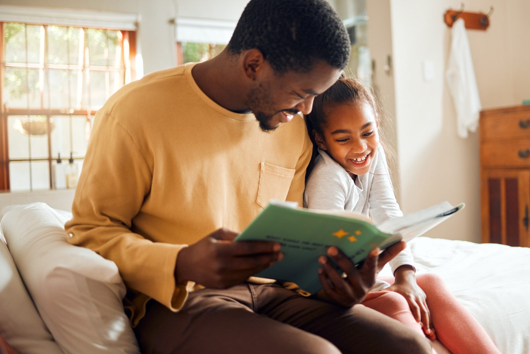 Father and daughter reading a book together